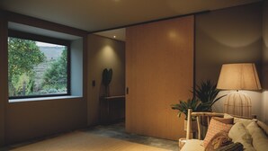 A modern living room with a large window, a sofa, a lamp, and a plant. - The gateway to the magnificent Douro Valley. High-value wine tourism! (Santa Marta de Penaguião)
