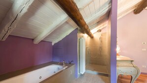 Een badkamer met een bad, douche en een wastafel met spiegel.