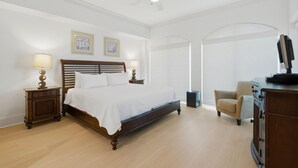 A bedroom with a bed, nightstands, a chair, a desk, and a ceiling fan. - Mustique 2001 (Gulf Shores)
