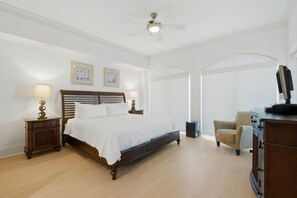 A bedroom with a bed, nightstands, a chair, a desk, and a ceiling fan. - Mustique 2001 (Gulf Shores)