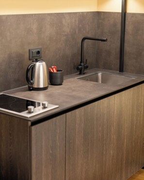 A modern kitchen with a built-in sink, a kettle, and a coffee maker. - Agara Stays Prizren (Prizren)