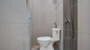 A small, enclosed shower stall with a toilet and a shower head. - Townhouse Oak near RSUD Dr. Zainoel Abi (Banda Aceh)