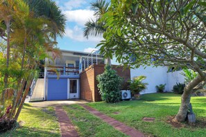 A residential property with a paved driveway, a wooden deck, and a small garden area. - Kaz vert - Piscine - Vue mer (Saint-Pierre)