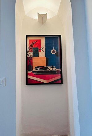 A framed abstract artwork on a wall in a hallway. - Piazza Condo   Suite with Balcony (ACQUASPARTA)