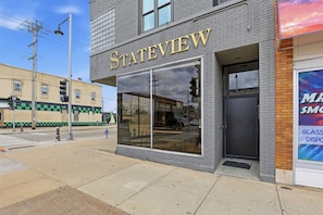 A building with a large glass storefront labeled 'Stateview.' - Stateview 203 - 1BR + Free Co-Working Space (Appleton)
