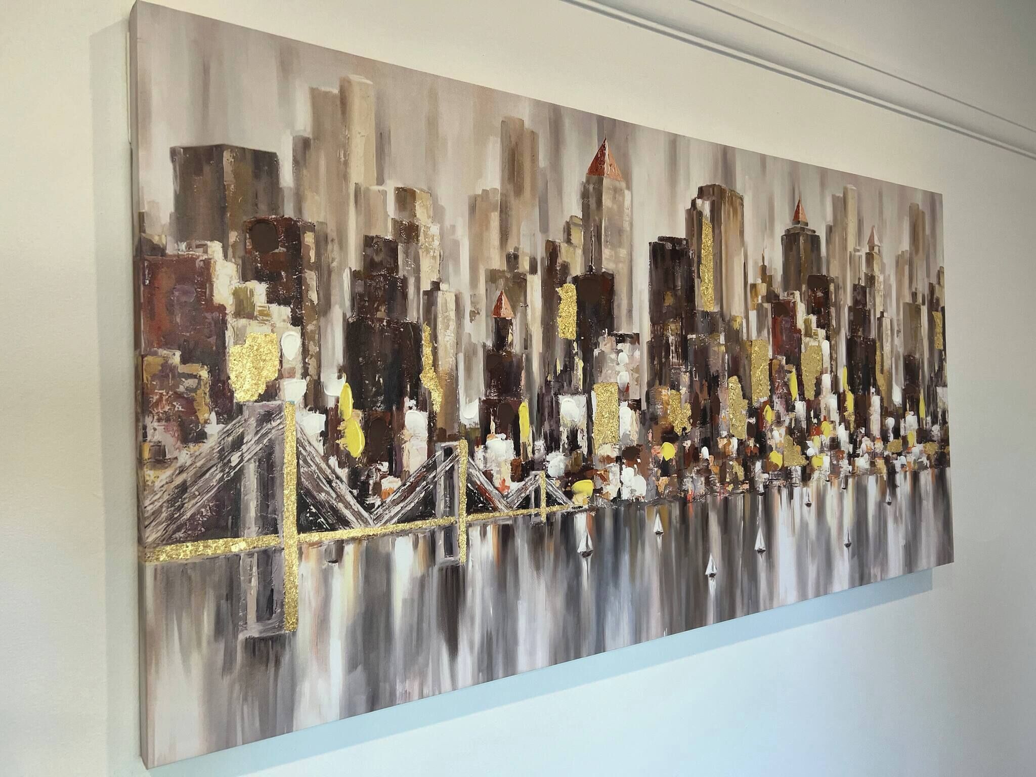 A painting of a cityscape with buildings and a bridge.