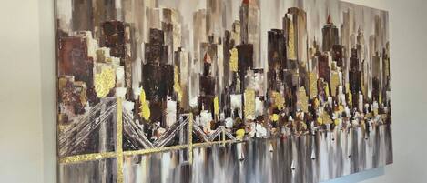 A painting of a cityscape with buildings and a bridge.