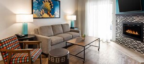 A modern living room with a sofa, armchair, coffee table, and a fireplace. - Winter Getaway Resort • 2BR Condo • Sleeps 6 • Jan 1–8 • On Golf Course (Scottsdale)