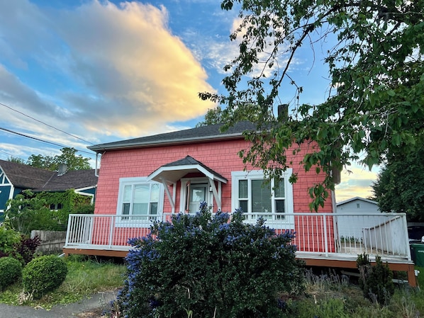 A two-story house with a red exterior, white trim, and a porch with a railing. - Heart of Old Town/Cozy 2BR Suite / Near Ferry & Sea Wall (Nanaimo)