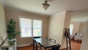 A dining area with a glass table, chairs, a ceiling fan, and a view of the outdoors through windows. - Lux- Minimum 2 -Lexington With-Riverwalk & CAE (West Columbia)