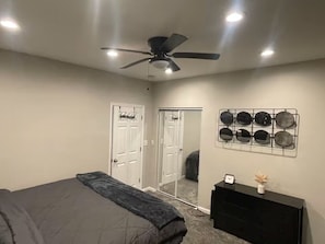 A bedroom with a bed, a ceiling fan, a dresser, and a wall-mounted mirror. - 7 Minutes From DRAFT! (Pittsburgh)