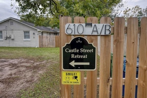 A wooden sign with '610 A/B' and 'Castle Street Retreat' pointing left. - Castle Street Retreat - The Rustic Whiskey (Wilmington)