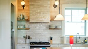 A kitchen with a stove, oven, and a window. - Historic 1915 Home · No Pet Fees (Chattanooga)