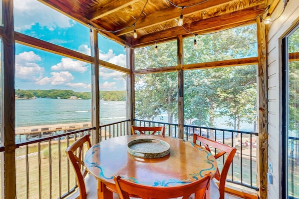 A wooden deck with a table and chairs, overlooking a body of water and trees. - Another Tequila Sunrise - Lakefront Condo W/breathtaking Views & Wheelchair Accessibility (Moneta)