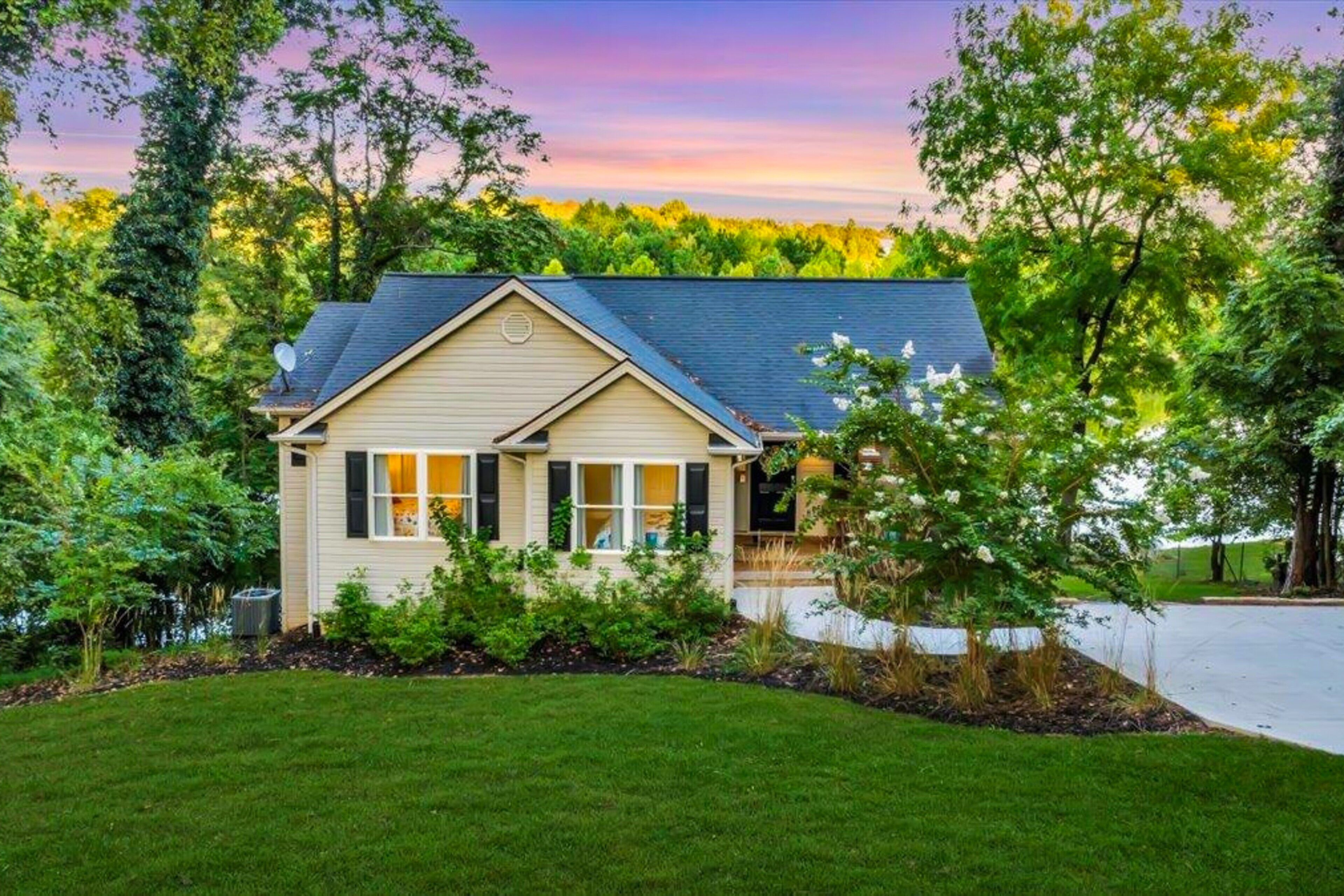A single-story house with a gabled roof, a front porch, and a well-maintained lawn.