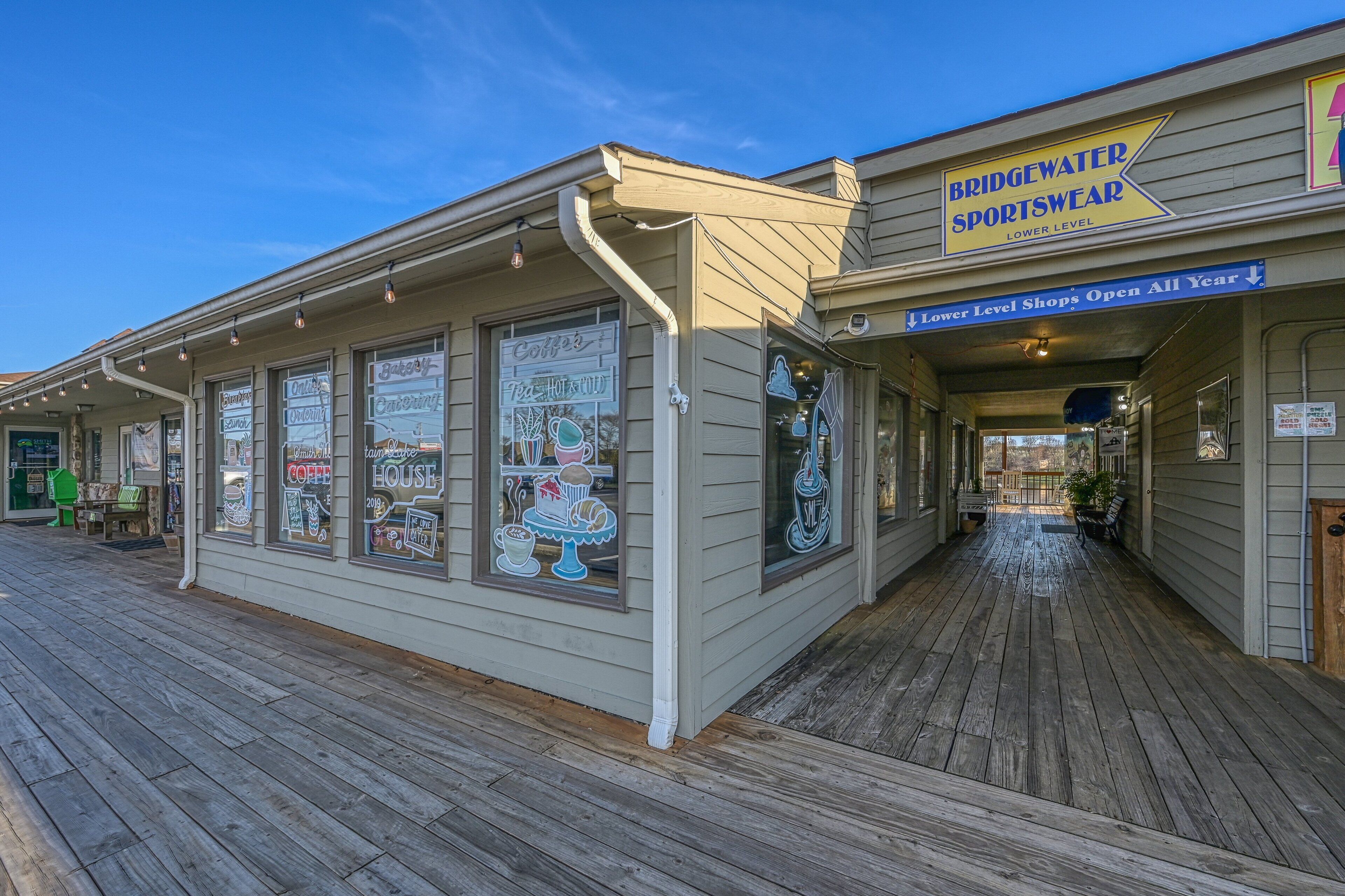 A waterfront building with a sign for Bridgewater Sportswear and Lower Level Shops.