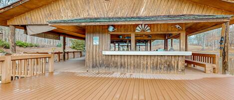 A wooden pavilion with a covered seating area and a sign indicating it is a private room.
