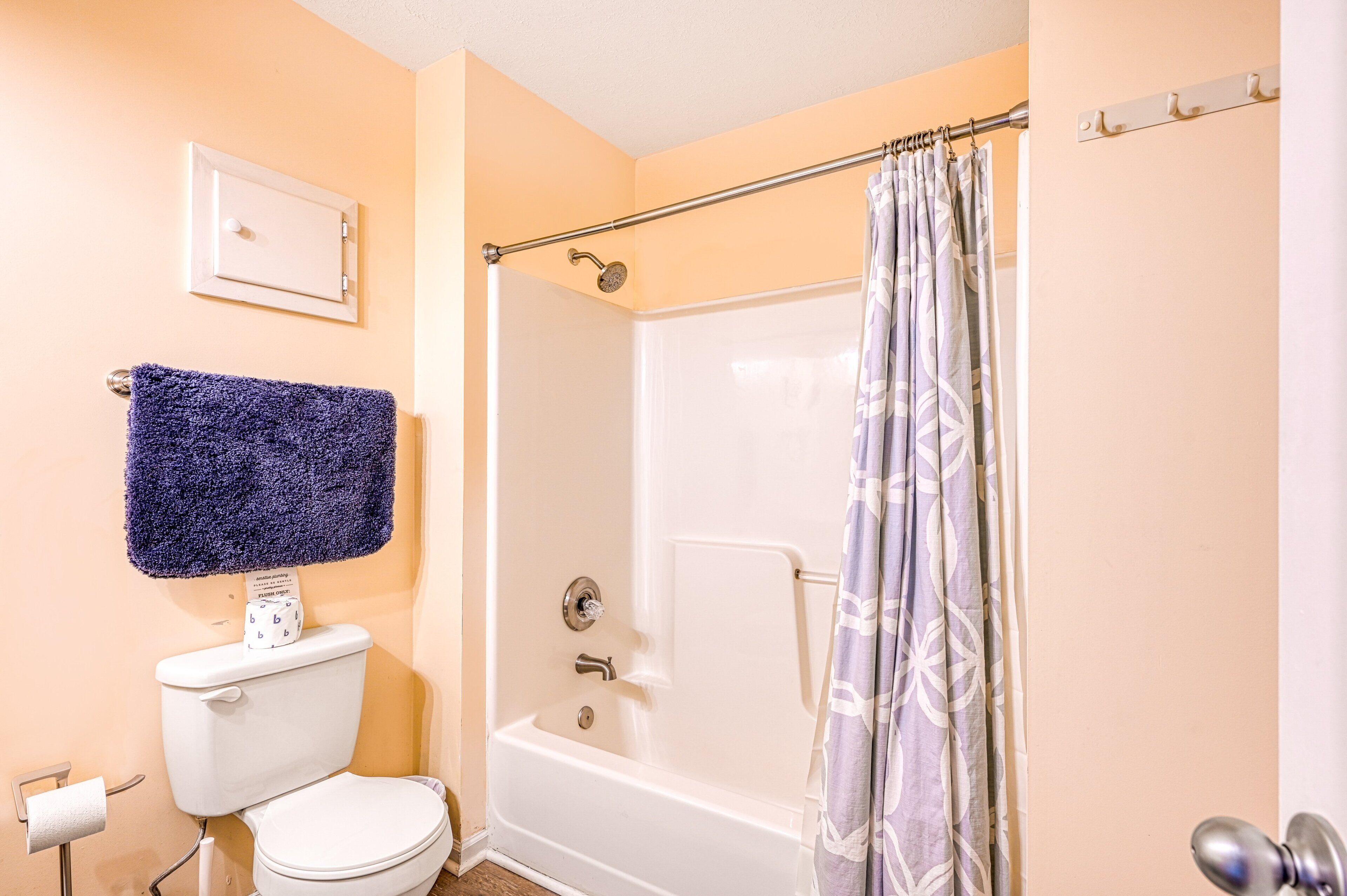 A bathroom with a toilet, a shower, and a bathtub.