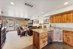 A spacious kitchen with wooden cabinets, a granite countertop, and a built-in dishwasher. - Ski/Lake condo near Basin/Powder/Nordic/Pineview (Eden)