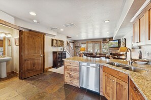 A spacious kitchen with granite countertops, stainless steel appliances, and wooden cabinetry. - Ski/Lake condo near Basin/Powder/Nordic/Pineview (Eden)