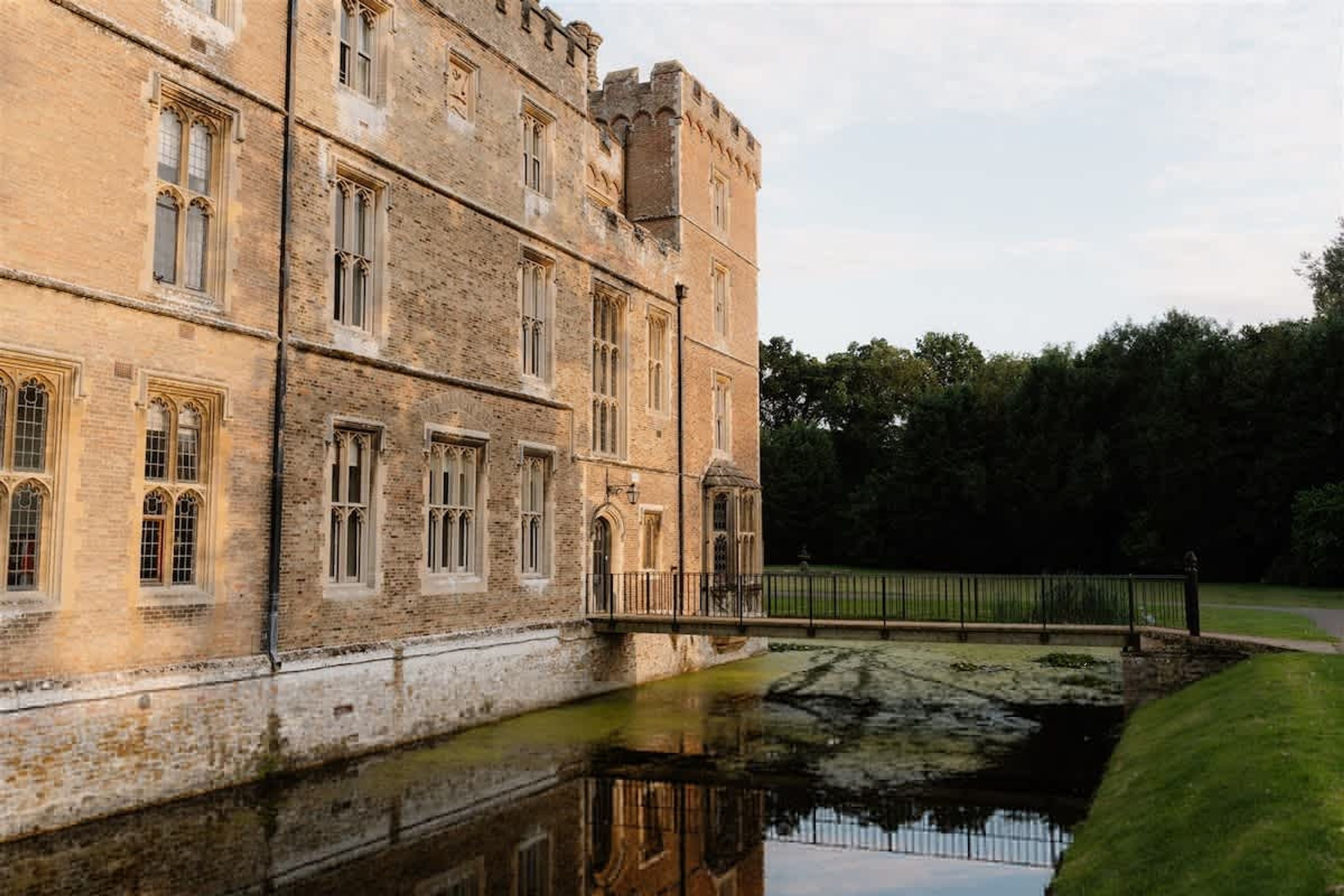 A historic building with multiple windows and a moat.