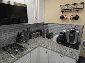 A kitchen with a gas stove, a microwave, a coffee maker, and a toaster. - Private Studio - 10 minutes from LV Strip, airport, and Convention Center (Las Vegas)