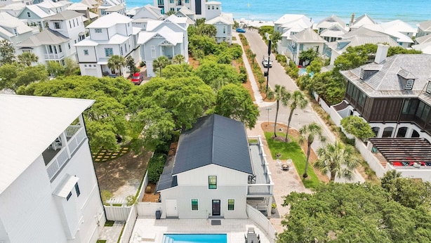 A coastal residential area with houses, a swimming pool, and a view of the ocean. - Charming Inlet Beach Compound | Pool + Walk to Rosemary Beach (Inlet Beach)
