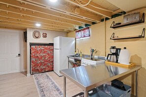 A kitchen with a refrigerator, stove, sink, and various kitchen items. - The  Yellowbike  Den (Livingston)