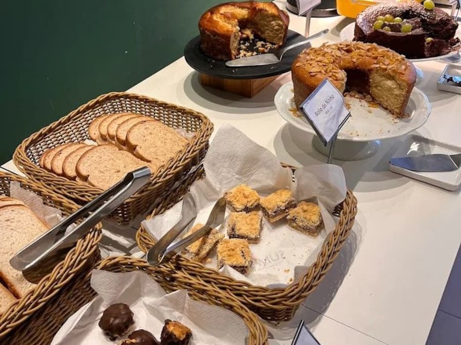 Un bufé con diversos alimentos, incluyendo pan, pasteles y postres.
