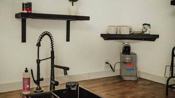 Fridge, microwave, coffee/tea maker, cookware/dishes/utensils