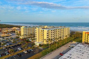 A high-rise hotel with multiple balconies overlooking a beach. - Gorgeous 2BR Condo W/ Partial Ocean View, Balcony, Pool, Hot Tub! 🍹🏖️ (Cocoa Beach)