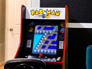A Pac-Man arcade game with a score display and joystick controls.