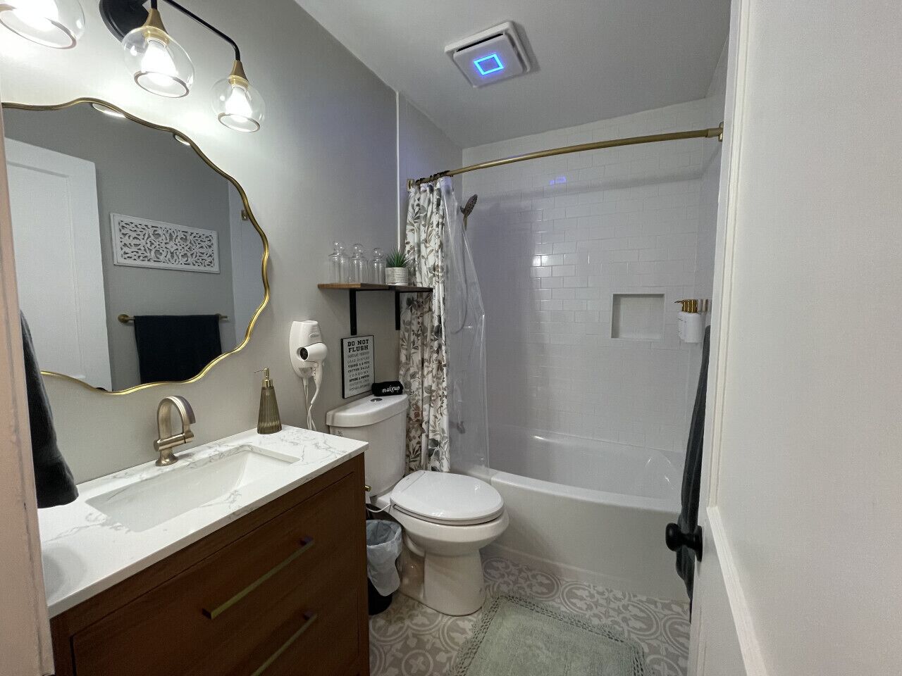 A bathroom with a sink, toilet, and shower.