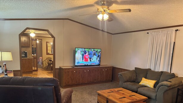 A living room with a television, a wooden cabinet, a sofa, and a coffee table. - Steps from Lake Fork w/ private boat ramp access! (Emory)