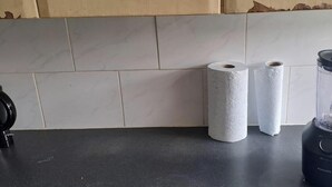 A kitchen counter with a blender, two rolls of paper towels, and a kettle. - Birmingham Bliss Retreat (Birmingham)