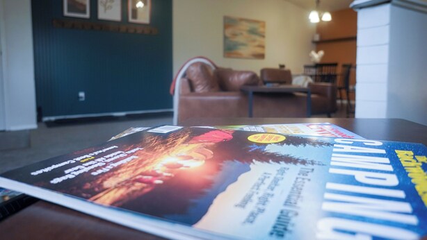 A magazine on a table with a view of a living room.