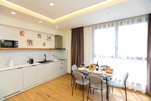 A modern kitchen with a dining area, featuring a microwave, toaster, and sink. - La Dimora Azzurra 103, Vlore, Albania (Vlore)