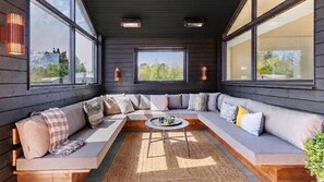 A modern interior with a sectional sofa, large windows, and a central coffee table. - VillaVilla 960 - Østersøbadet, Lolland/Falster/Møn (Rødby)