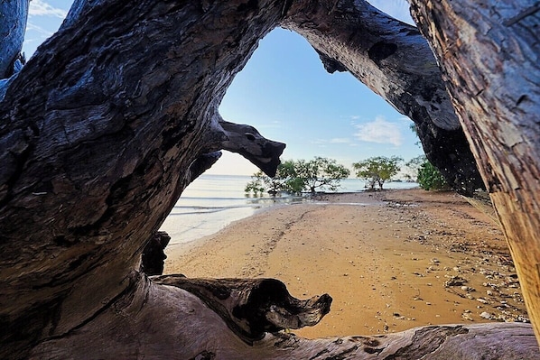 A natural rock formation framing a beach view. - Jasmine Beachside | 60 Secs to Beach, Heated Pool, Whale Season & Fraser Island (Scarness)