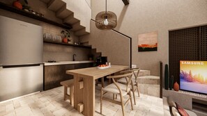 A modern kitchen with a wooden table and chairs, a built-in stove, and a Samsung TV. - Stylish 2-Bedroom Private Villa in Badung Near Canggu (Badung)