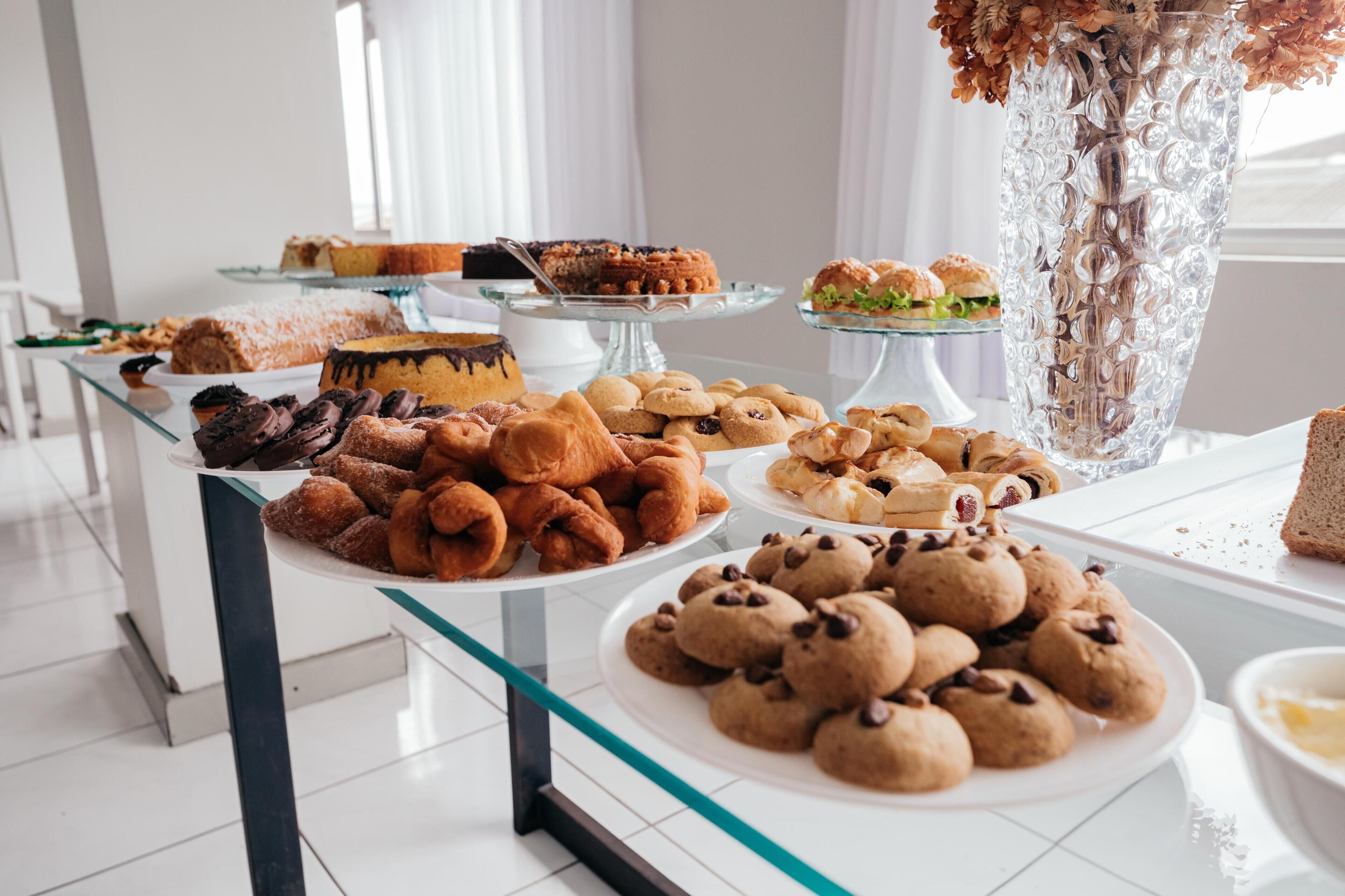 A buffet table with various baked goods and desserts.