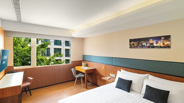 A hotel room with a bed, desk, chair, and a cityscape view through the window. - Just Sleep Taipei Zhongshan (Taipei)