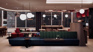 A modern interior with a seating area, tables, and a bar. - Just Sleep Taipei Zhongshan (Taipei)