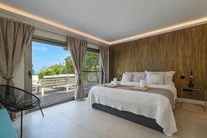 A modern bedroom with a large bed, a view to the outside, and a balcony. - Villa Amantos - Denia, Costa Blanca (Denia)