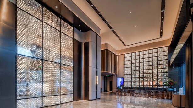 A modern lobby with a glass partition, a reception desk, and a large digital screen. - Crystal Orange Shenzhen Bao'an Joy City (Shenzhen)