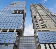 Two high-rise buildings with a clear sky.
