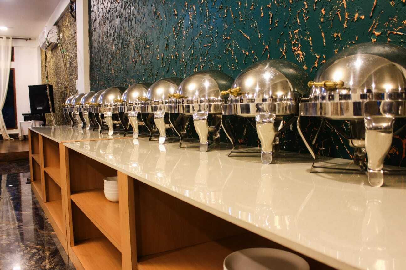 A long, polished counter with multiple shiny, dome-shaped objects lined up.