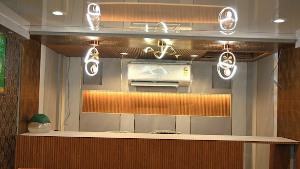 A reception desk with a modern design, including a wooden panel and a built-in air conditioning unit.