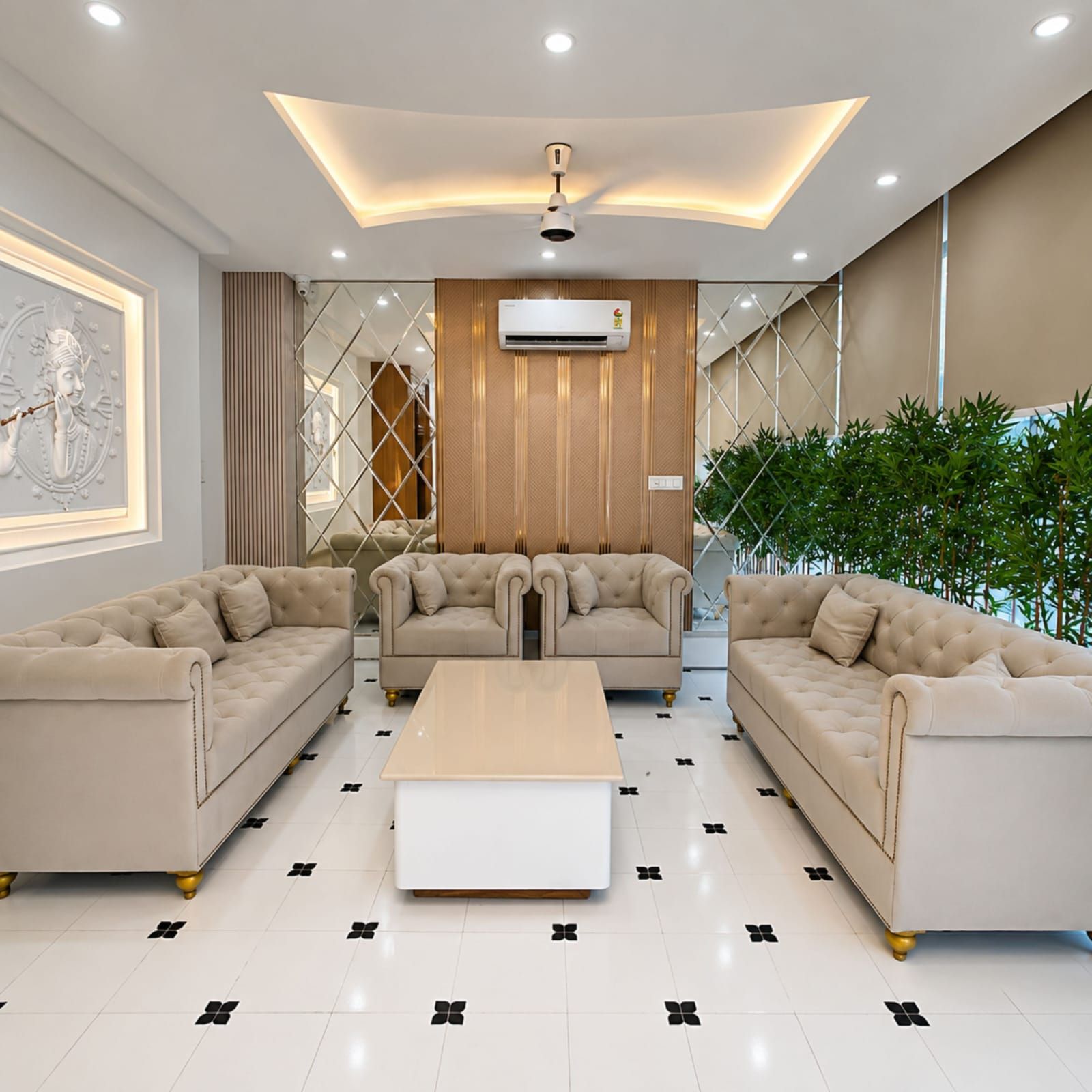 A modern living room with a central sofa, two armchairs, a coffee table, and a decorative wall piece.