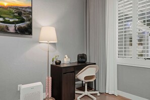 A corner room with a desk, chair, lamp, and a window with blinds. - Relaxing 5BR Tempe Home family pool moder home (Tempe)